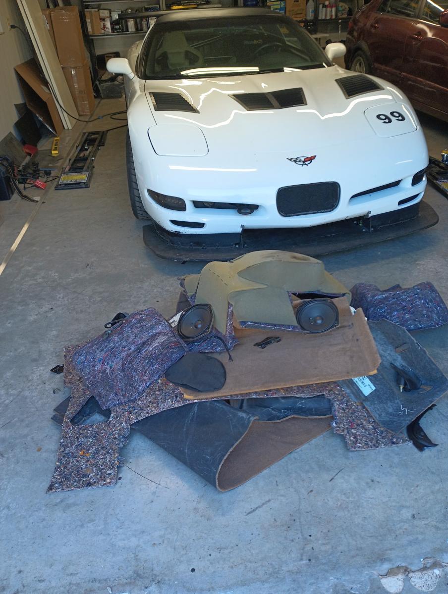 Shred Jesse's C5 Corvette with a pile of carpet, carpet padding and other bits and bobs from stripping the rear compartment of the Corvette down.