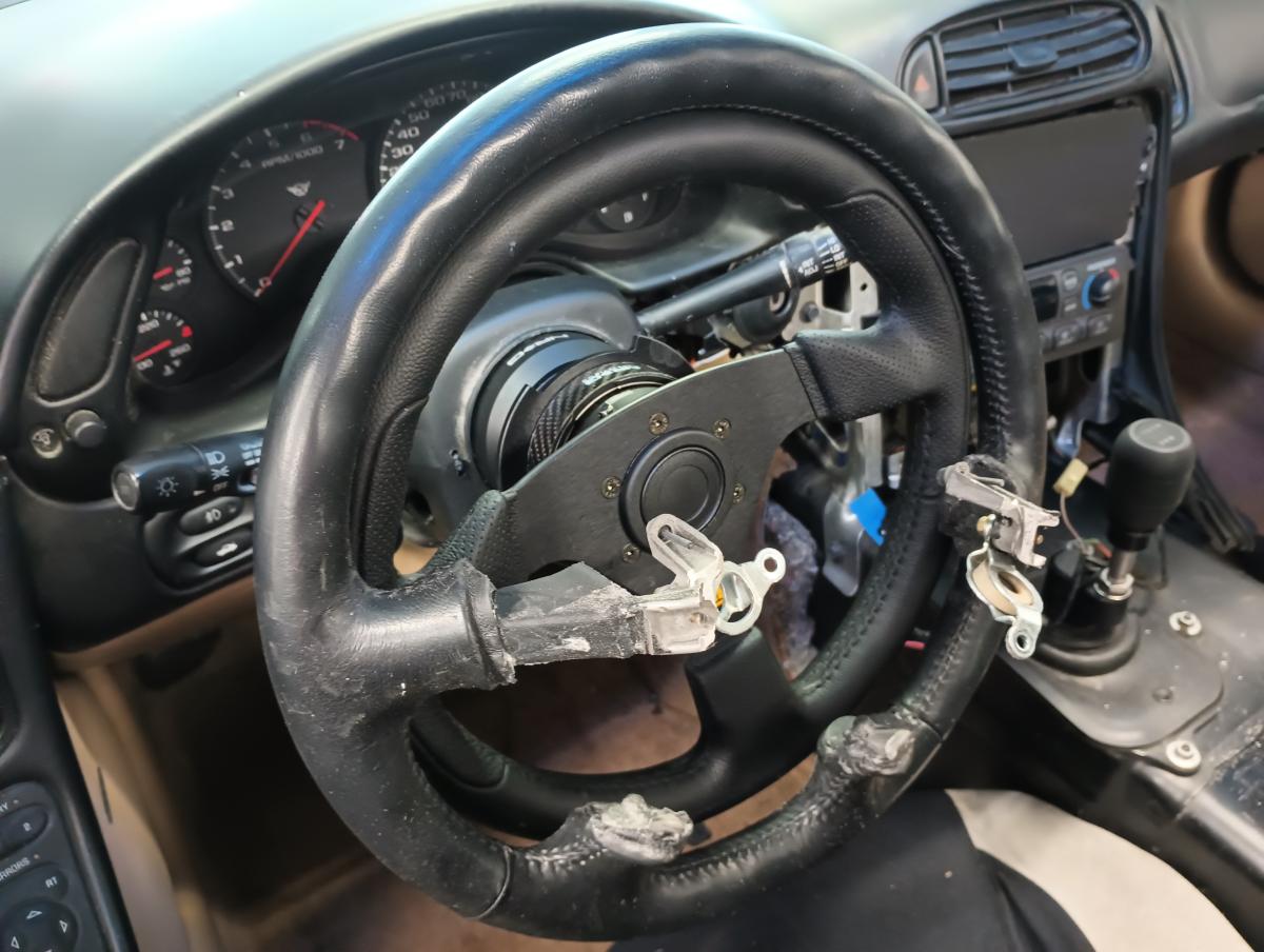 Example of a 330mm steering wheel on a C5 Corvette with the OEM steering wheel put around it to demonstrate that 50mm difference in circumference.