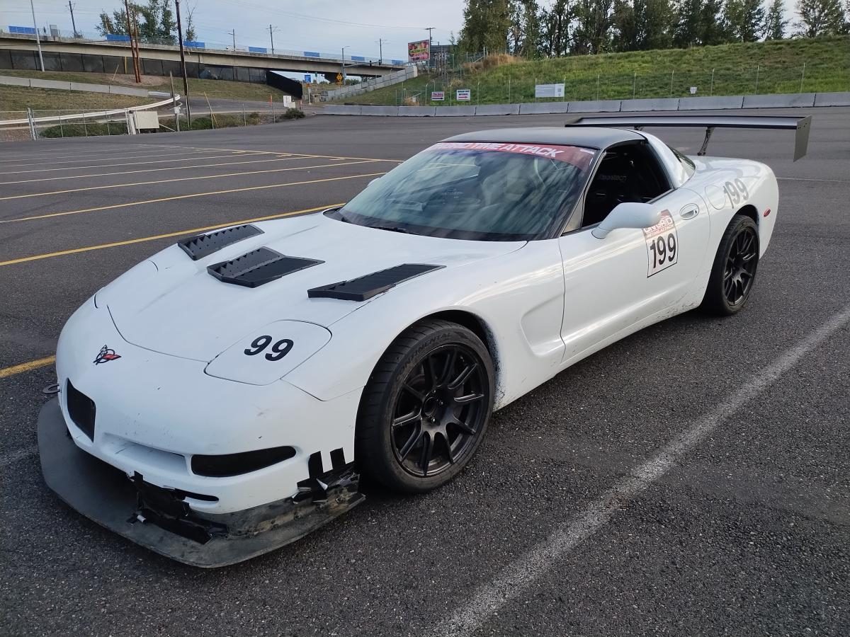 Shred Jesse's white 1999 C5 Corvette with full aero parked at Portland International Raceway