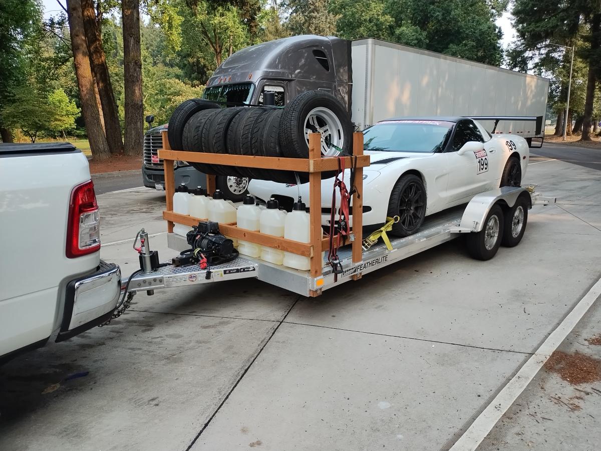 Shred Jesse's C5 Corvette as being towed to the event, with the new DIY tire and fuel rack on the front of the trailer.